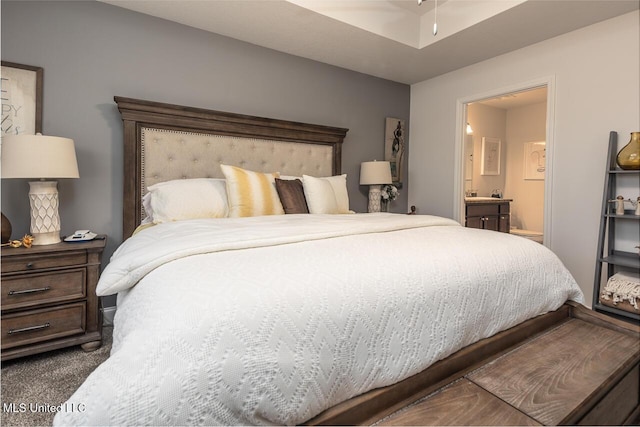 carpeted bedroom with ensuite bath