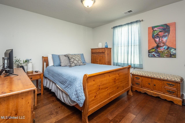 bedroom featuring dark hardwood / wood-style flooring