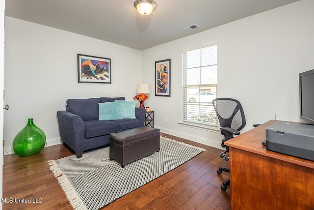 office space with dark wood-type flooring