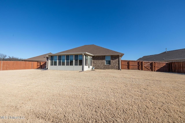 rear view of property with a sunroom