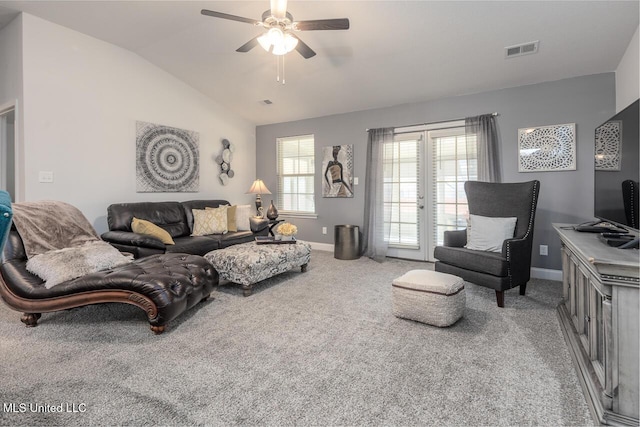 living room with lofted ceiling, ceiling fan, and carpet