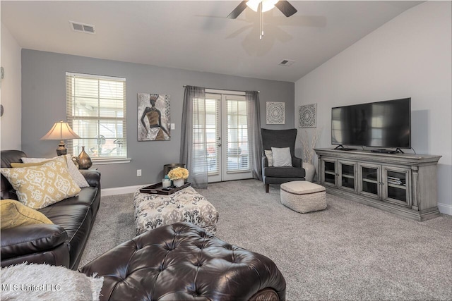 carpeted living room featuring vaulted ceiling, a wealth of natural light, ceiling fan, and french doors