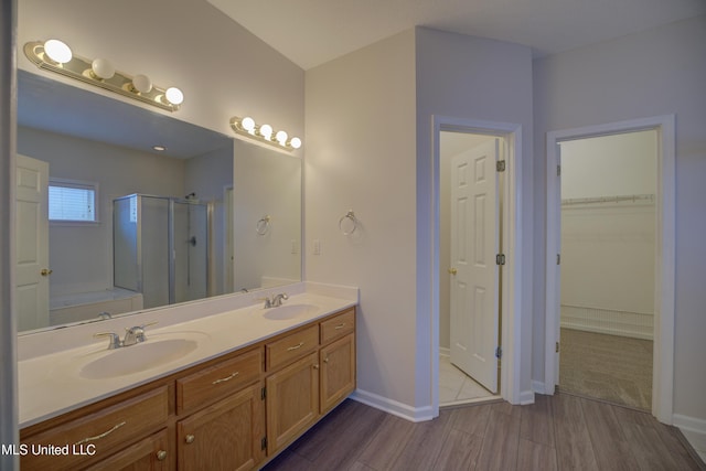 bathroom with vanity, separate shower and tub, and hardwood / wood-style floors