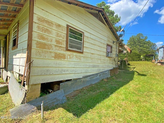 view of side of property with a yard