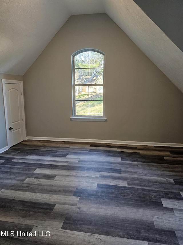 bonus room featuring lofted ceiling, wood finished floors, and baseboards