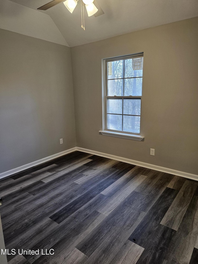 unfurnished room featuring dark wood finished floors, baseboards, lofted ceiling, and a ceiling fan