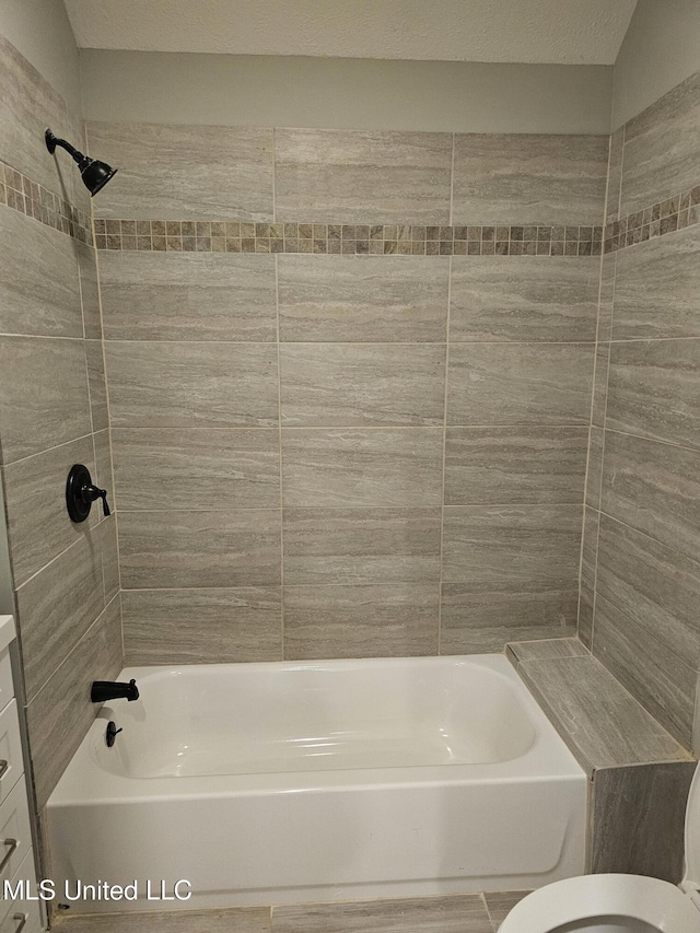 bathroom with toilet and shower / washtub combination