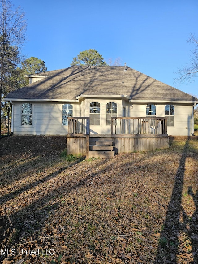 back of house featuring a deck