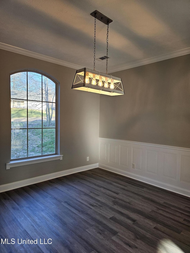 unfurnished dining area with visible vents, crown molding, baseboards, and dark wood-style flooring