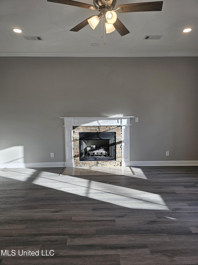 unfurnished living room featuring visible vents, a stone fireplace, and ornamental molding