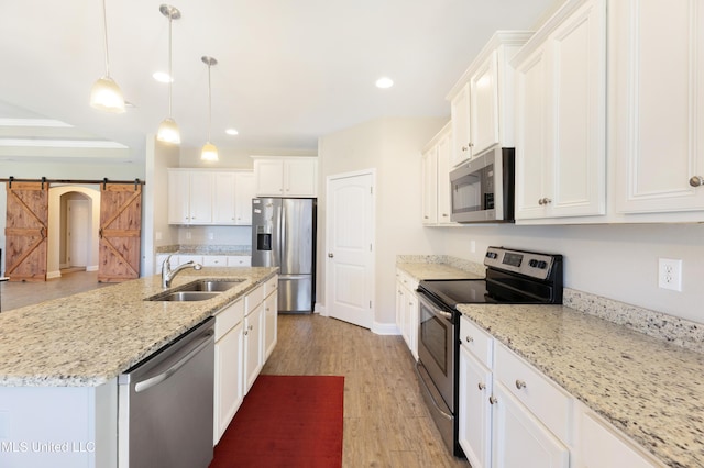 kitchen featuring white cabinetry, stainless steel appliances, and a sink