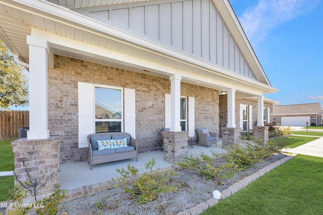 view of patio featuring covered porch and fence