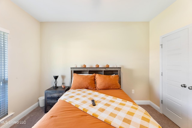 bedroom with carpet floors and baseboards