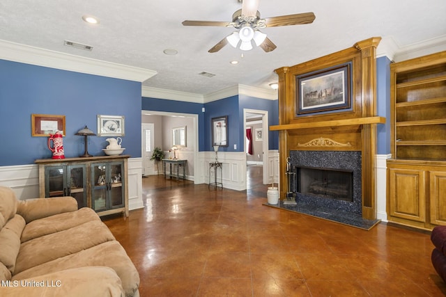 114 Sandstone Dr, Brandon, MS 39047 - living area featuring ceiling fan, a premium fireplace, a decorative wall, crown molding, and a wainscoted wall