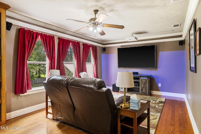 114 Sandstone Dr, Brandon, MS 39047 - cinema room featuring crown molding, baseboards, wood finished floors, a ceiling fan, and a textured ceiling