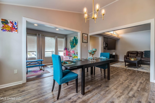 dining room featuring vaulted ceiling, wood-type flooring, and ornamental molding