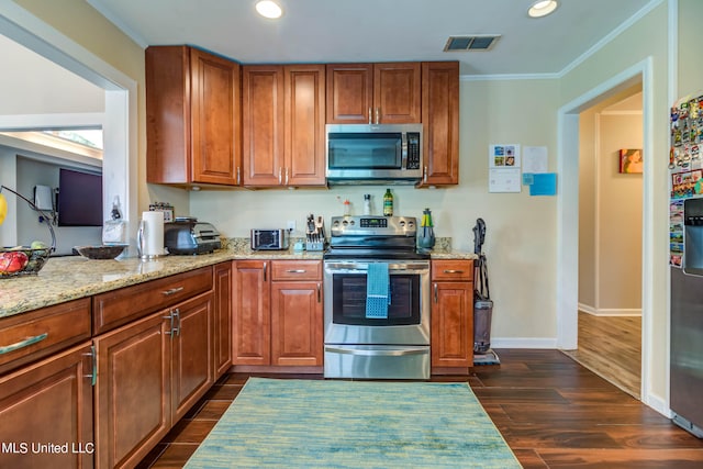 kitchen featuring light stone countertops, appliances with stainless steel finishes, dark hardwood / wood-style flooring, and ornamental molding