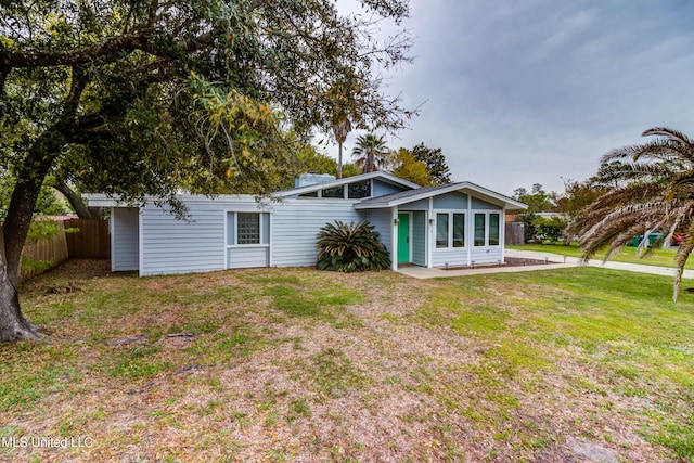 rear view of property featuring a yard