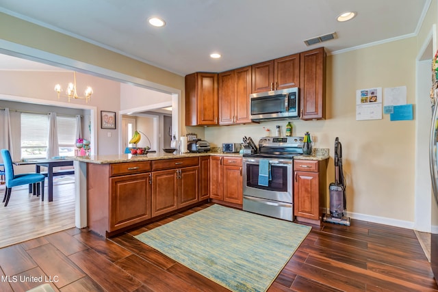 kitchen featuring kitchen peninsula, dark hardwood / wood-style flooring, an inviting chandelier, light stone countertops, and stainless steel appliances