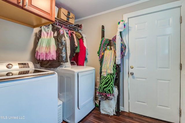 laundry area with crown molding, independent washer and dryer, dark hardwood / wood-style floors, and cabinets