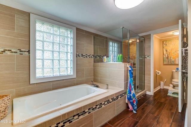 bathroom with plenty of natural light, toilet, ornamental molding, and separate shower and tub