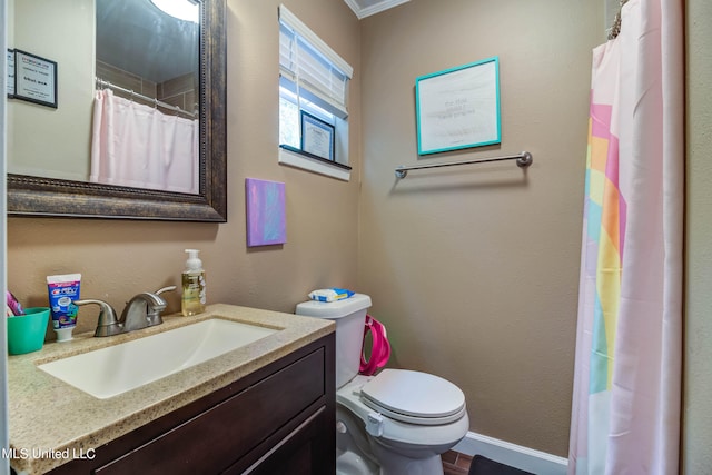 bathroom featuring vanity, toilet, and ornamental molding