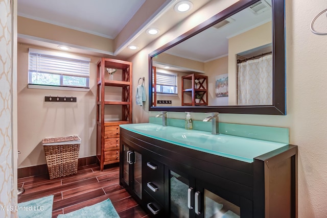 bathroom featuring vanity, crown molding, and hardwood / wood-style floors