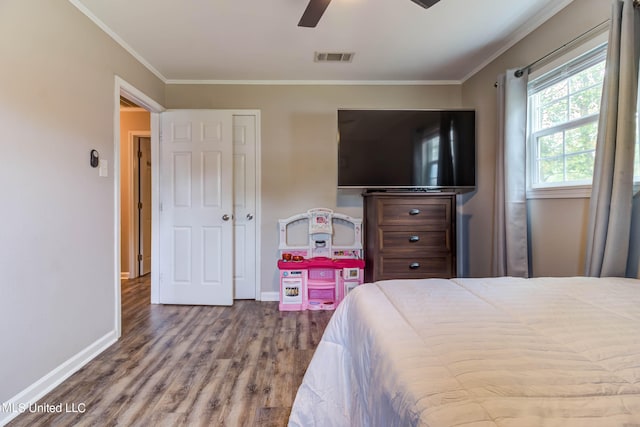 bedroom with ornamental molding, hardwood / wood-style flooring, and ceiling fan