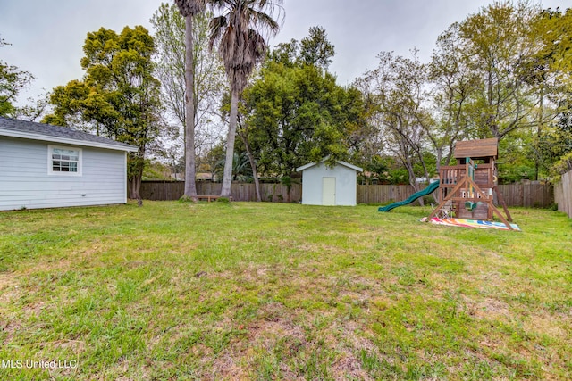 view of yard featuring a storage shed and a playground