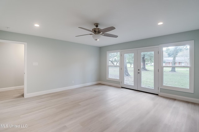 empty room featuring french doors, light hardwood / wood-style floors, and ceiling fan