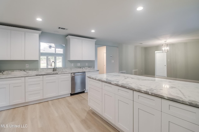 kitchen featuring sink, stainless steel dishwasher, light wood-type flooring, a notable chandelier, and white cabinetry