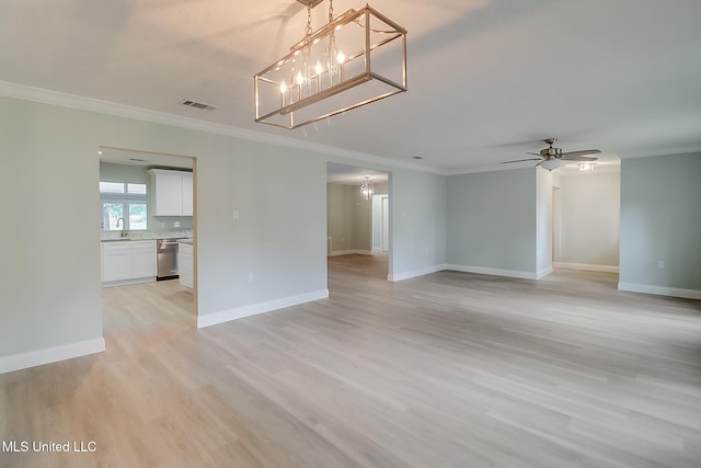 unfurnished room featuring crown molding, sink, and light hardwood / wood-style floors