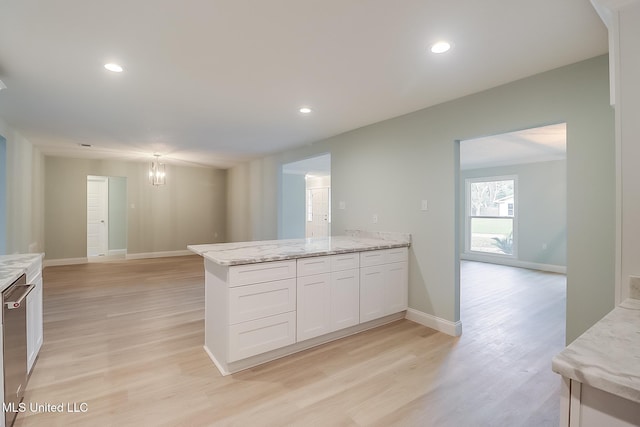 kitchen with dishwasher, light wood-type flooring, light stone counters, white cabinetry, and a chandelier