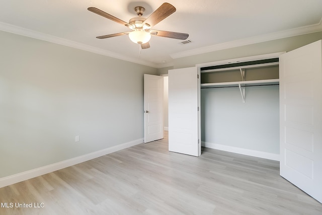 unfurnished bedroom with a closet, light hardwood / wood-style flooring, ceiling fan, and ornamental molding