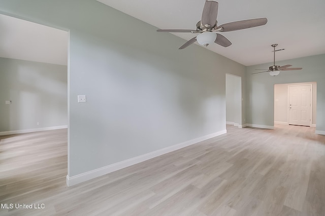 empty room with ceiling fan and light hardwood / wood-style floors