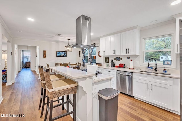 kitchen with sink, white cabinetry, stainless steel dishwasher, island range hood, and pendant lighting
