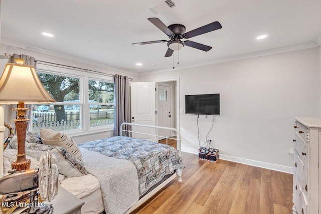 bedroom with ceiling fan, light hardwood / wood-style floors, and ornamental molding