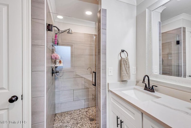 bathroom with a shower with door and vanity