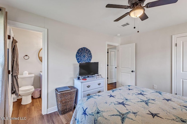 bedroom featuring ceiling fan, hardwood / wood-style floors, and ensuite bathroom