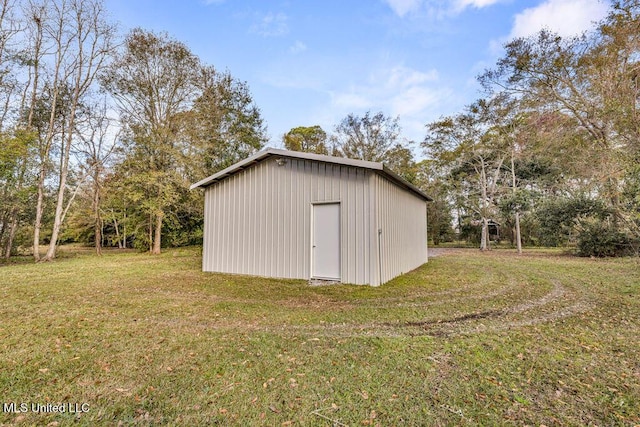 view of outbuilding with a yard