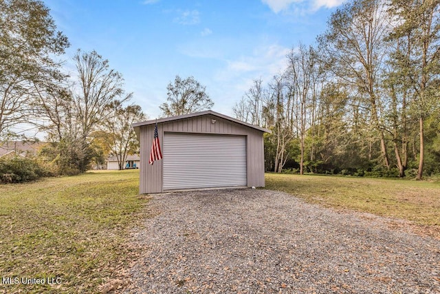garage featuring a lawn