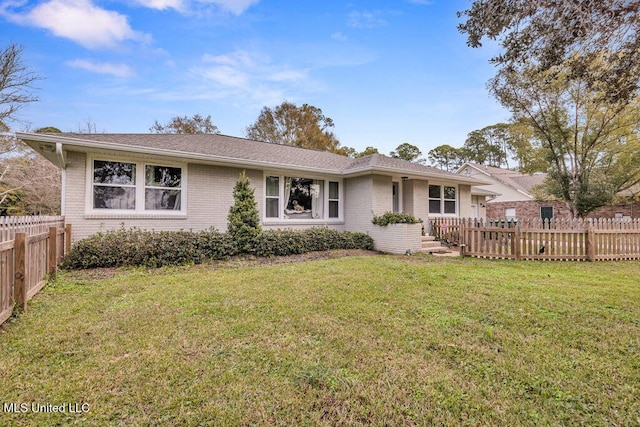 ranch-style home with a front lawn