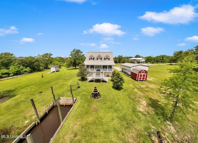 11020 Jordan Dr, Bay Saint Louis, MS 39520 - back of house featuring a yard, a porch, and metal roof