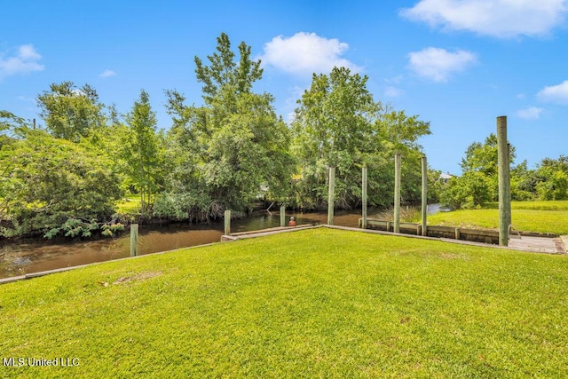 11020 Jordan Dr, Bay Saint Louis, MS 39520 - view of green lawn with a water view and view of wooded area