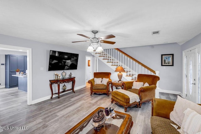 11020 Jordan Dr, Bay Saint Louis, MS 39520 - living room with ceiling fan, stairway, light wood-style flooring, and baseboards