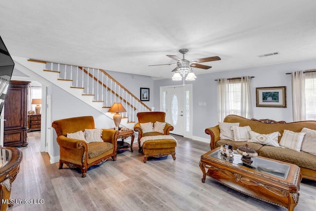 11020 Jordan Dr, Bay Saint Louis, MS 39520 - living room with stairway, wood finished floors, a ceiling fan, and baseboards