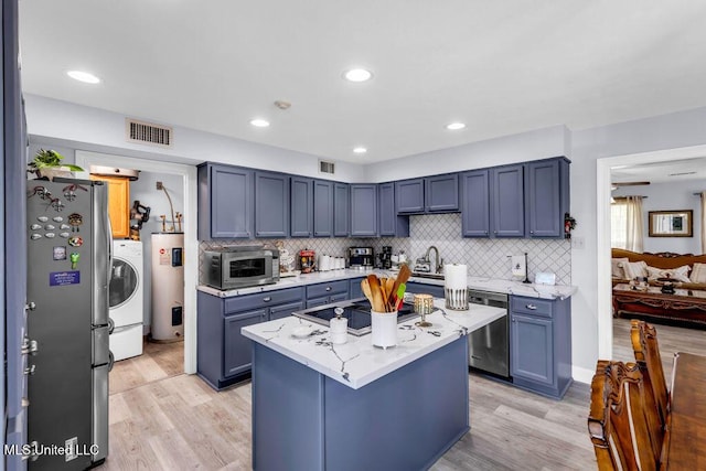 11020 Jordan Dr, Bay Saint Louis, MS 39520 - kitchen with appliances with stainless steel finishes, light wood-type flooring, tasteful backsplash, and recessed lighting