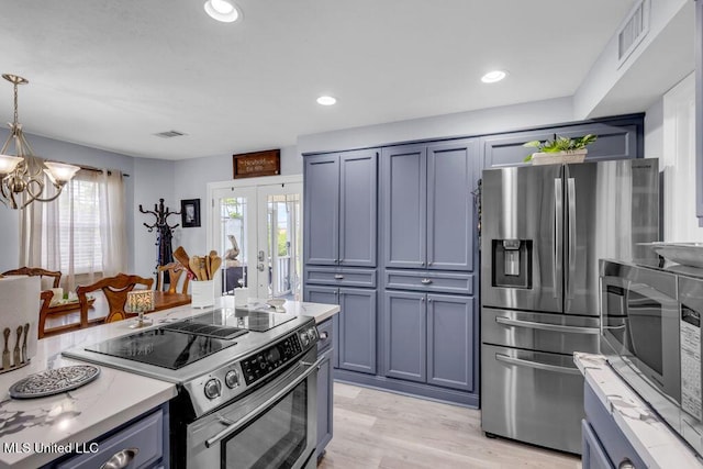 11020 Jordan Dr, Bay Saint Louis, MS 39520 - kitchen featuring stainless steel appliances, a chandelier, light wood finished floors, light stone countertops, and hanging light fixtures