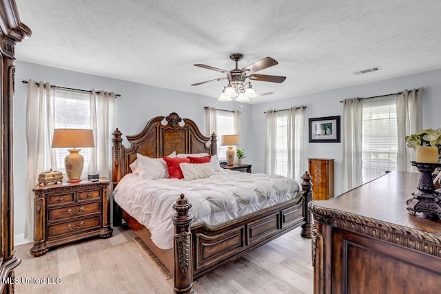 11020 Jordan Dr, Bay Saint Louis, MS 39520 - bedroom featuring light wood-type flooring, a textured ceiling, and ceiling fan
