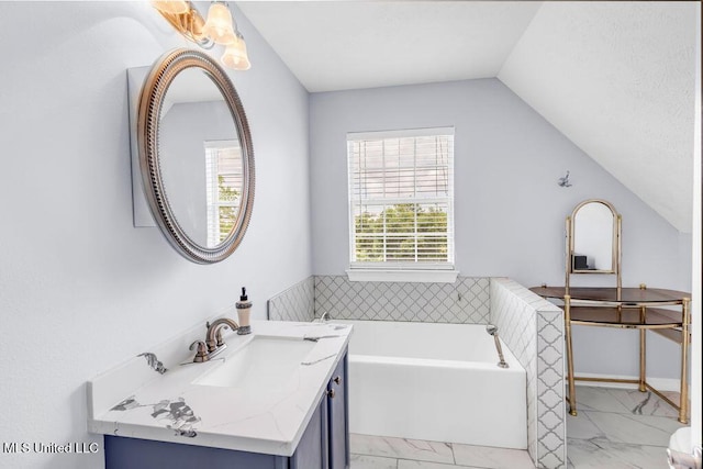 11020 Jordan Dr, Bay Saint Louis, MS 39520 - bathroom with marble finish flooring, vaulted ceiling, a bath, and vanity